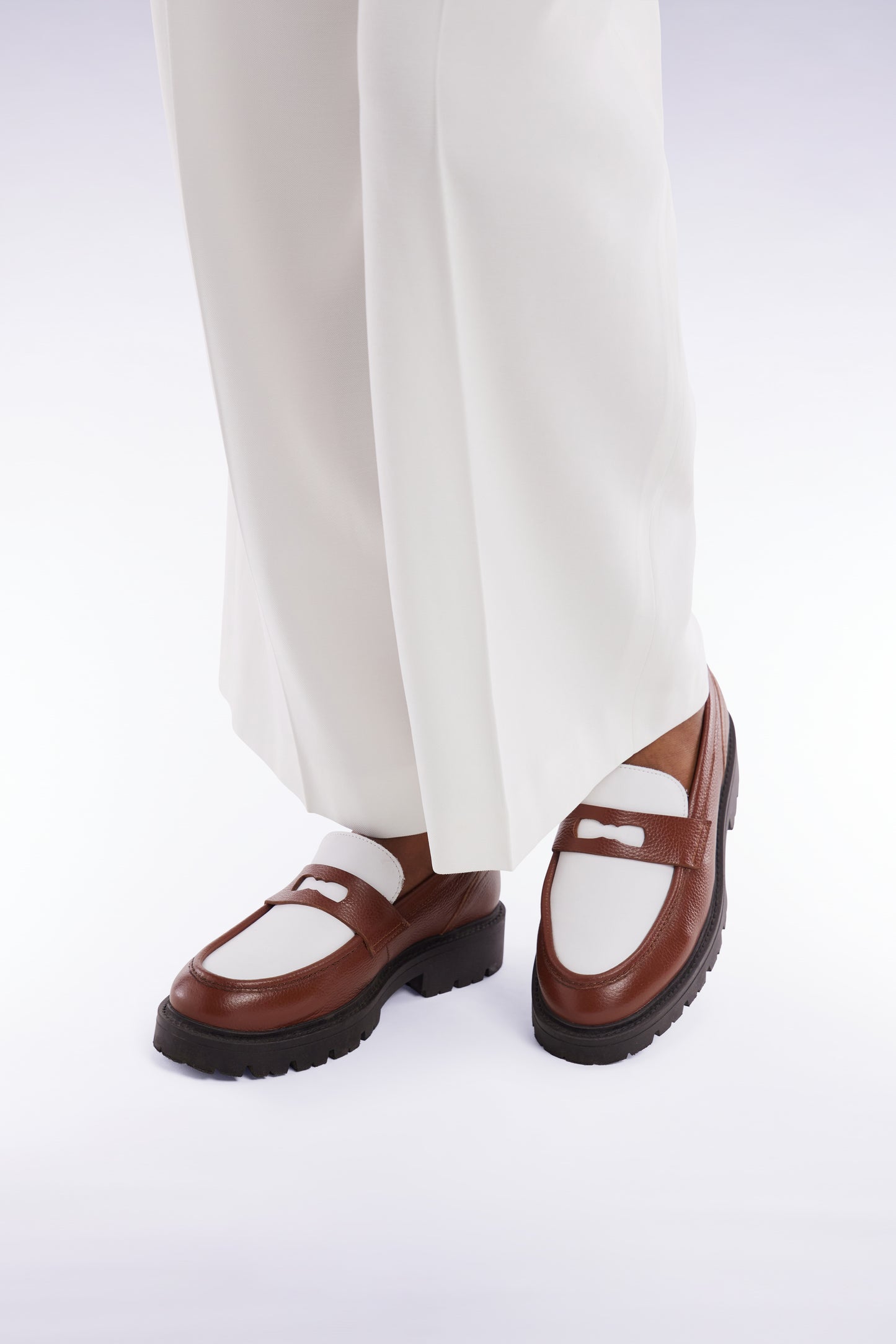 Two-tone brown and white leather loafers