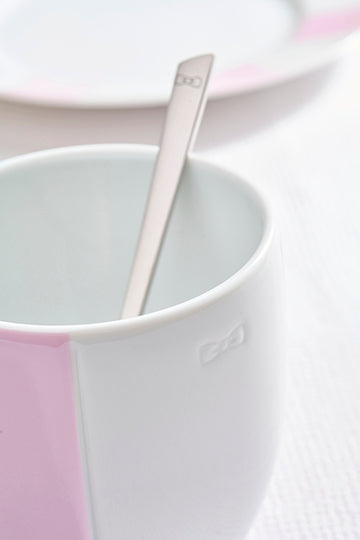 Set of two white Limoges porcelain mugs with pink enameled interior