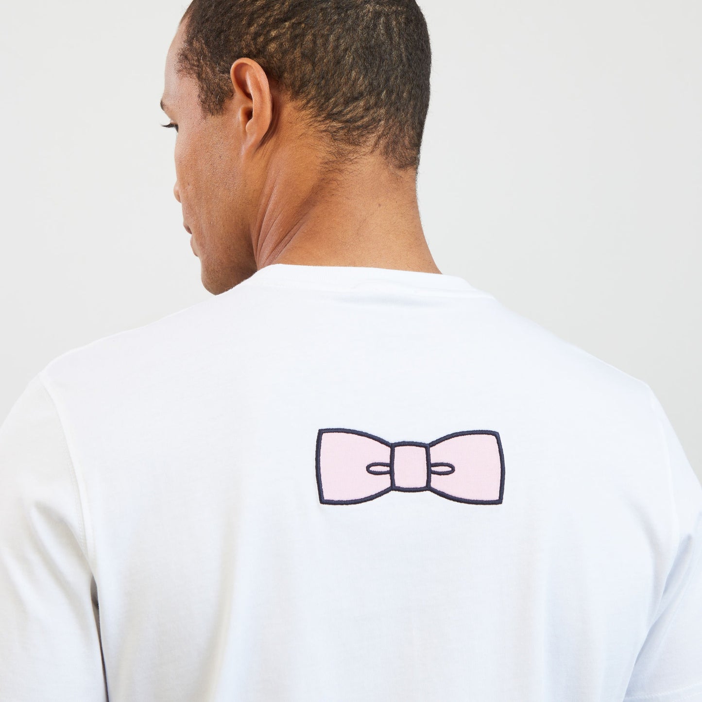 White T-shirt with embroidered bow tie on the back