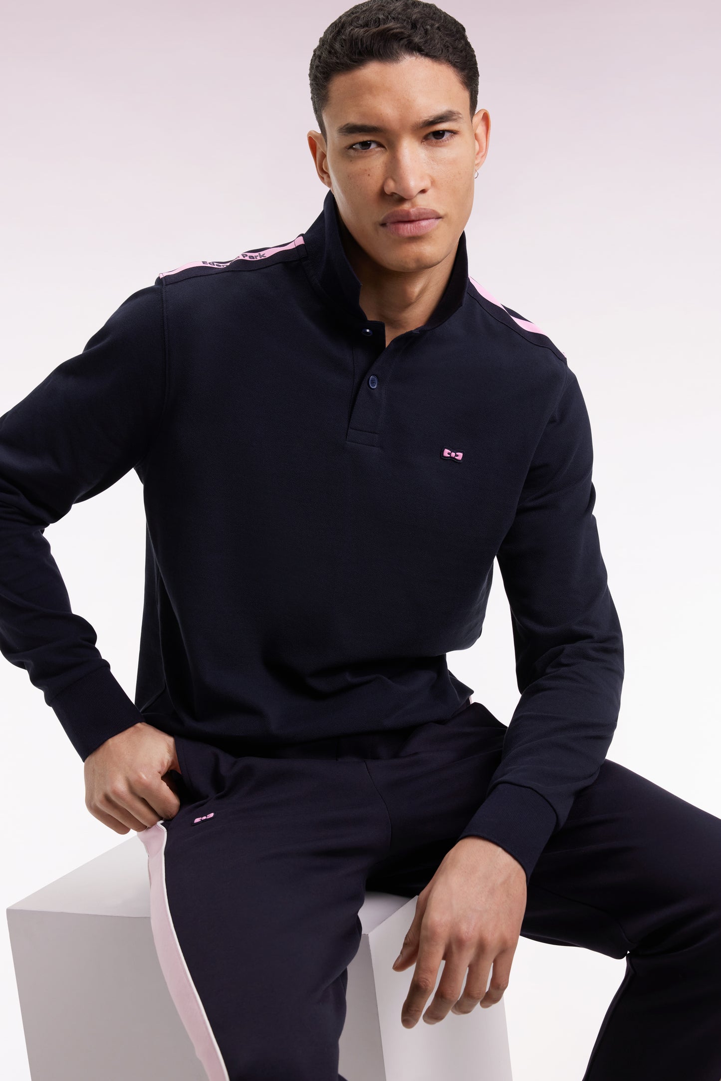 Long-sleeved polo shirt in navy cotton piqué with pink ribbon logo