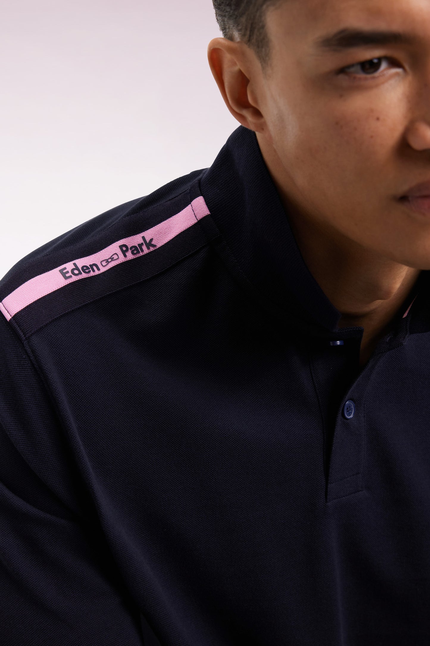 Long-sleeved polo shirt in navy cotton piqué with pink ribbon logo