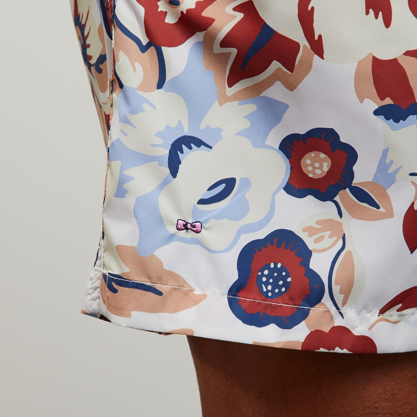 White swim shorts with exclusive floral print